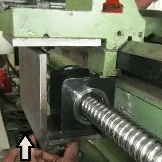 Inspecting the Z-axis ball screw on a bridge saw