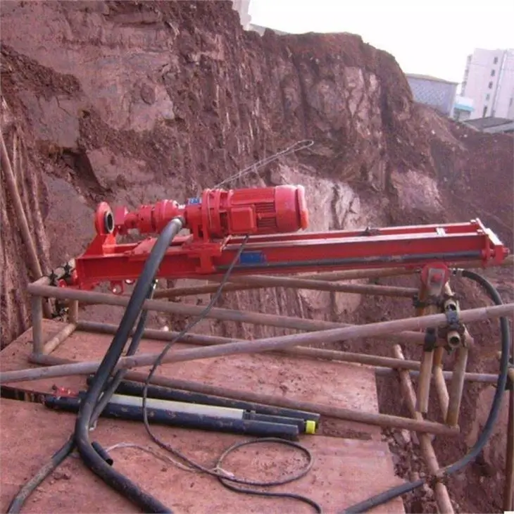 DTH driller executing a pull-back flush, lifting the rod slightly to blow out accumulated rock chips