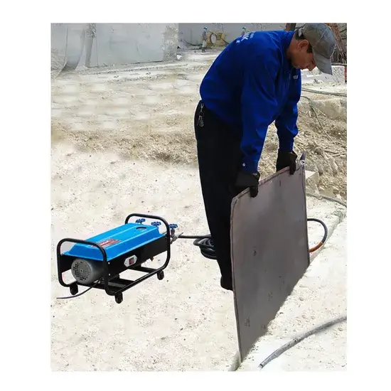 A hydrostatic pushing bag filled via a water line slowly and safely tipping a colossal granite base block