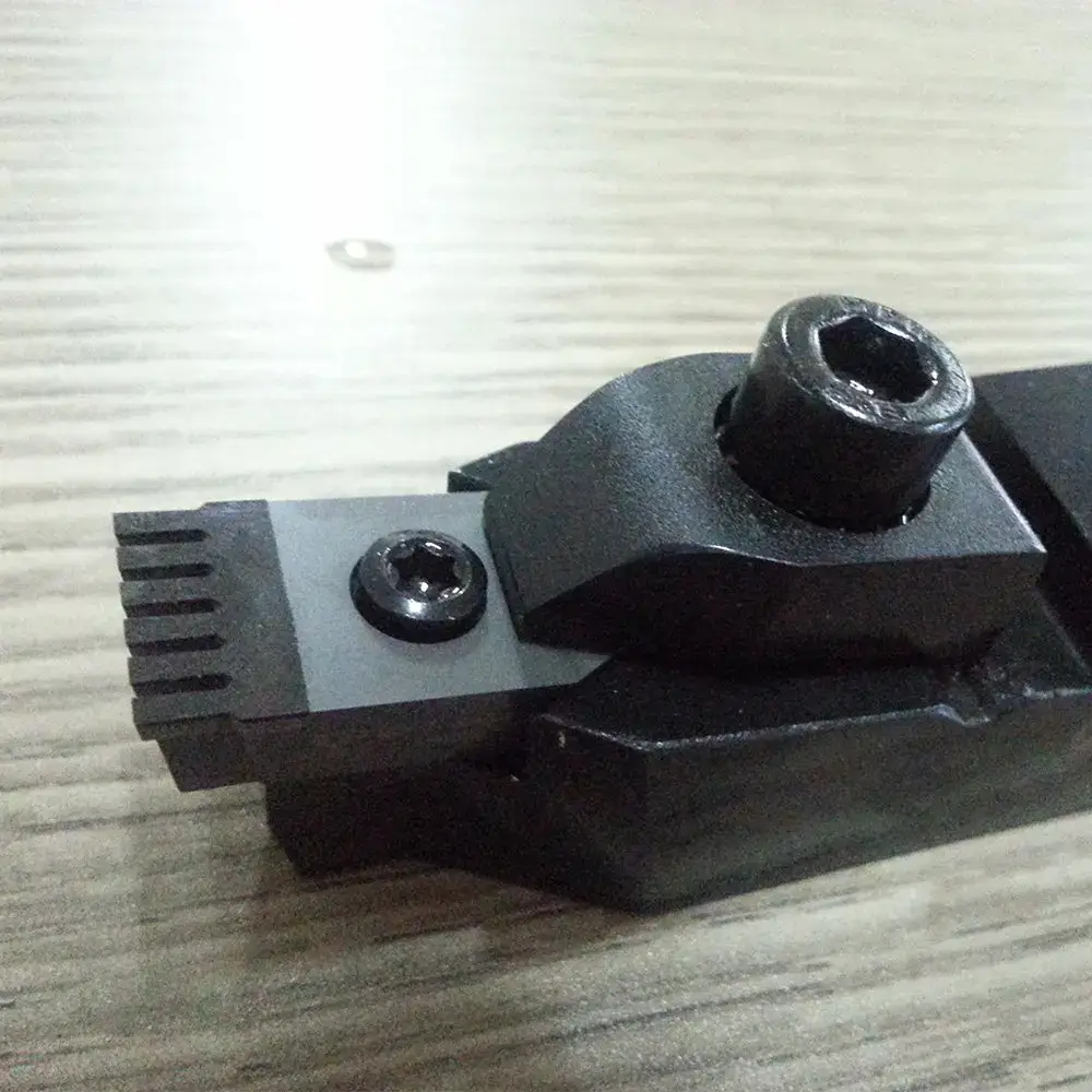 Chipped diamond chain saw insert inside a quarry machine holder