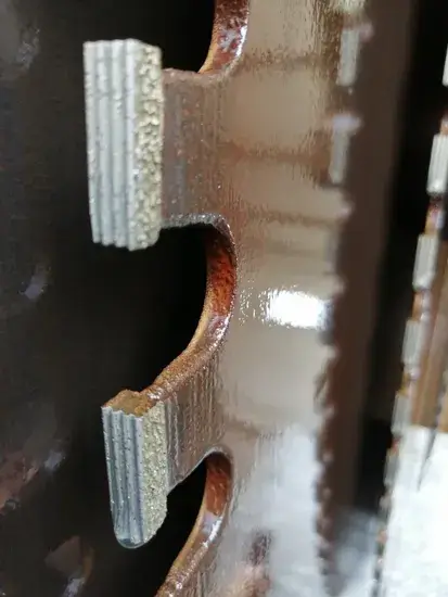 Cross-section of a MosCut diamond segment showing the multi-layer 'Sandwich' structure to prevent side wear